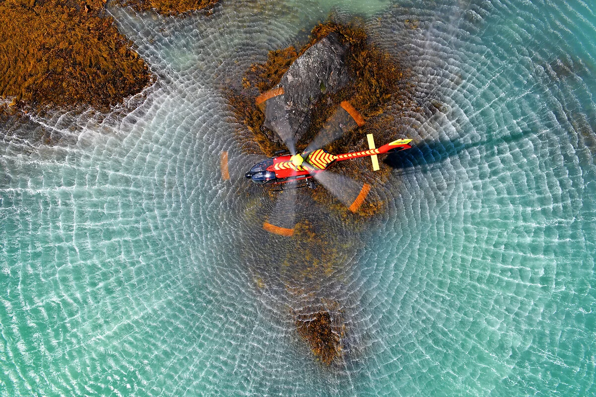 flying helicopter above water